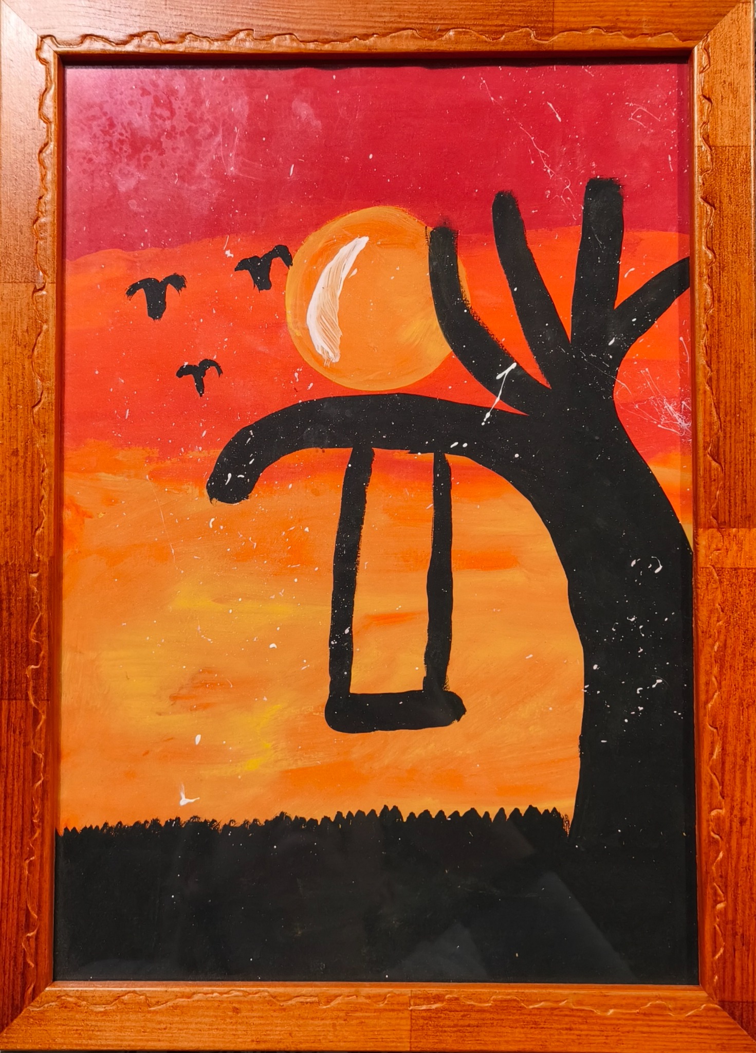 Orange sunset with a silhouetted tree, swing and birds in a wooden frame.